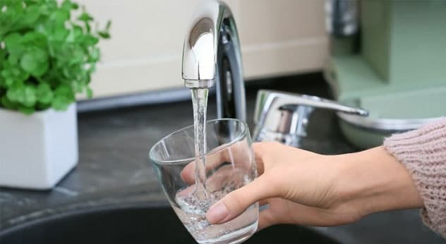 Homeowner practicing simple plumbing maintenance habits to prevent issues